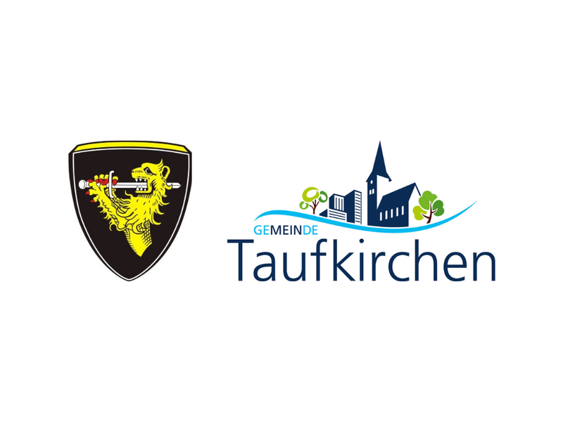 Das Bild zeigt links ein Wappen mit einem gelben Löwen auf schwarzem Hintergrund und rechts das Logo der Gemeinde Taufkirchen mit stilisierten Gebäuden und Bäumen.